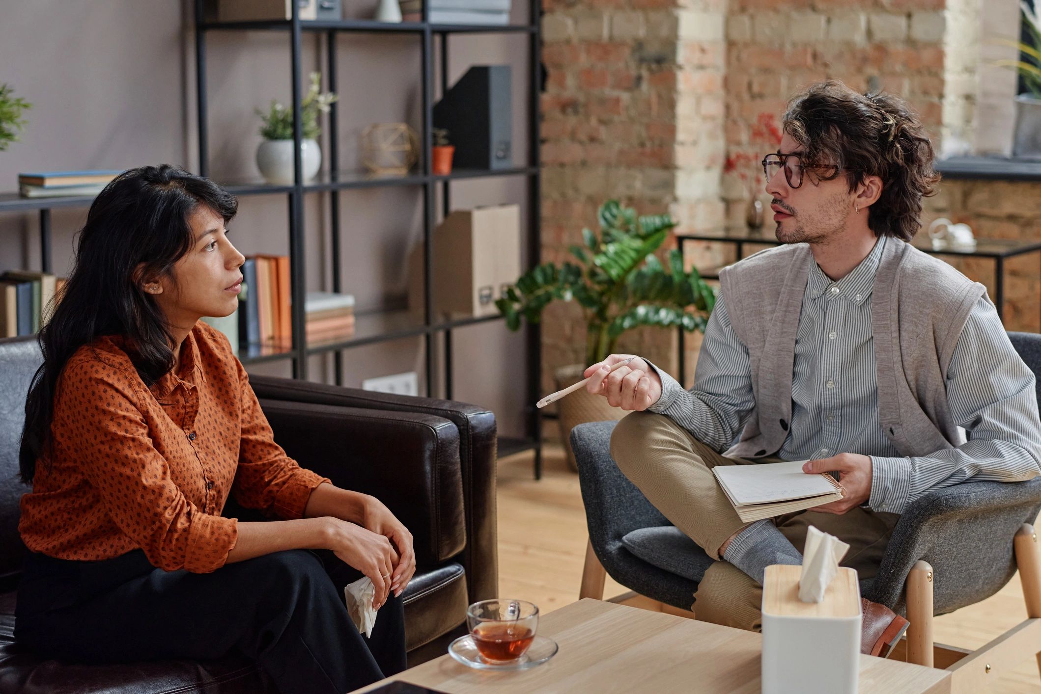 Diverse therapy session between two adults in a calm counseling office
