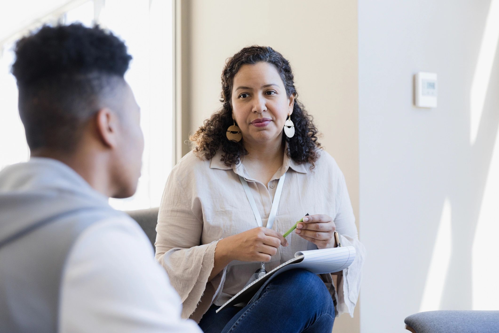 Counselor listening attentively during a teen therapy session
