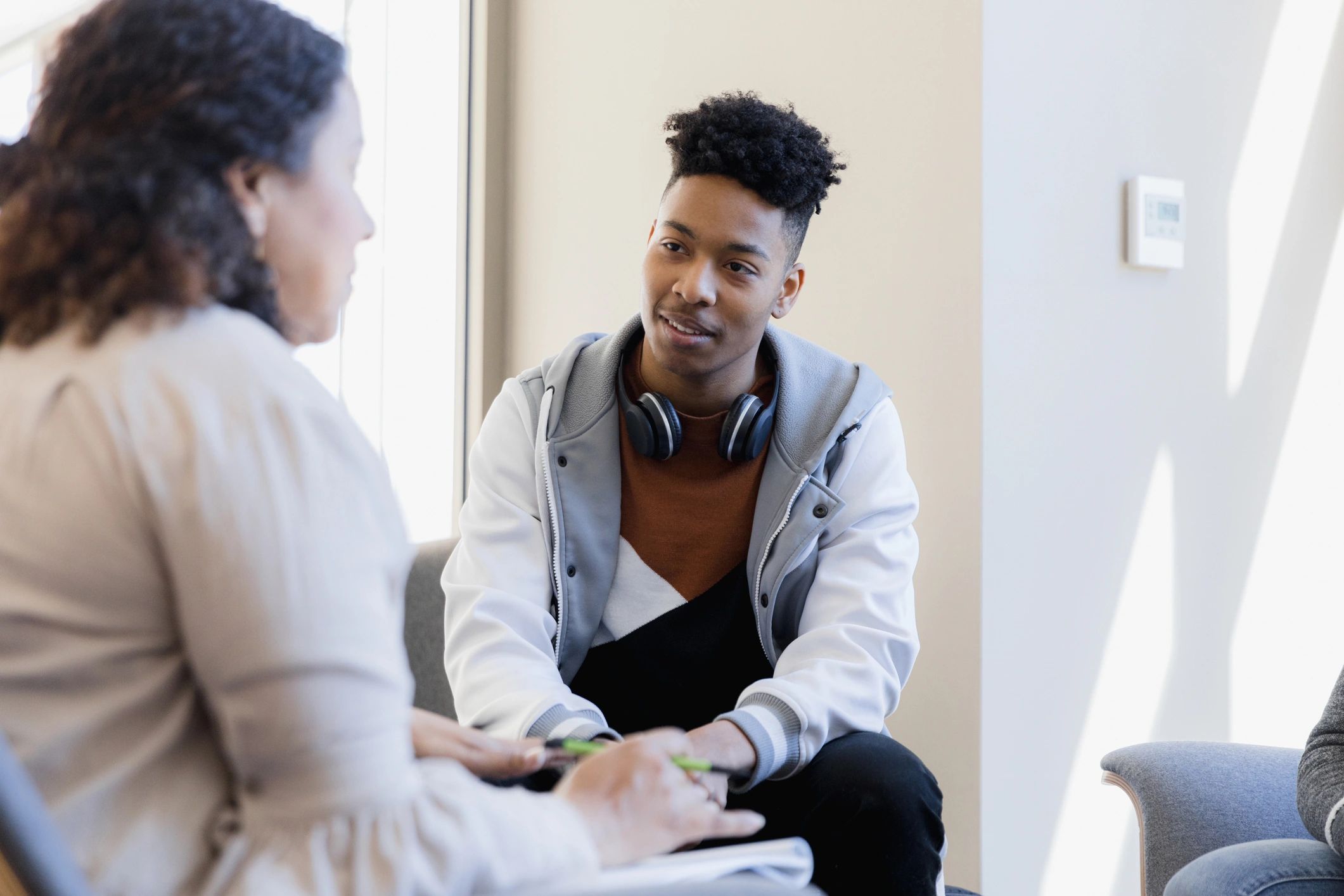 Therapist speaking with a young person during a counseling session