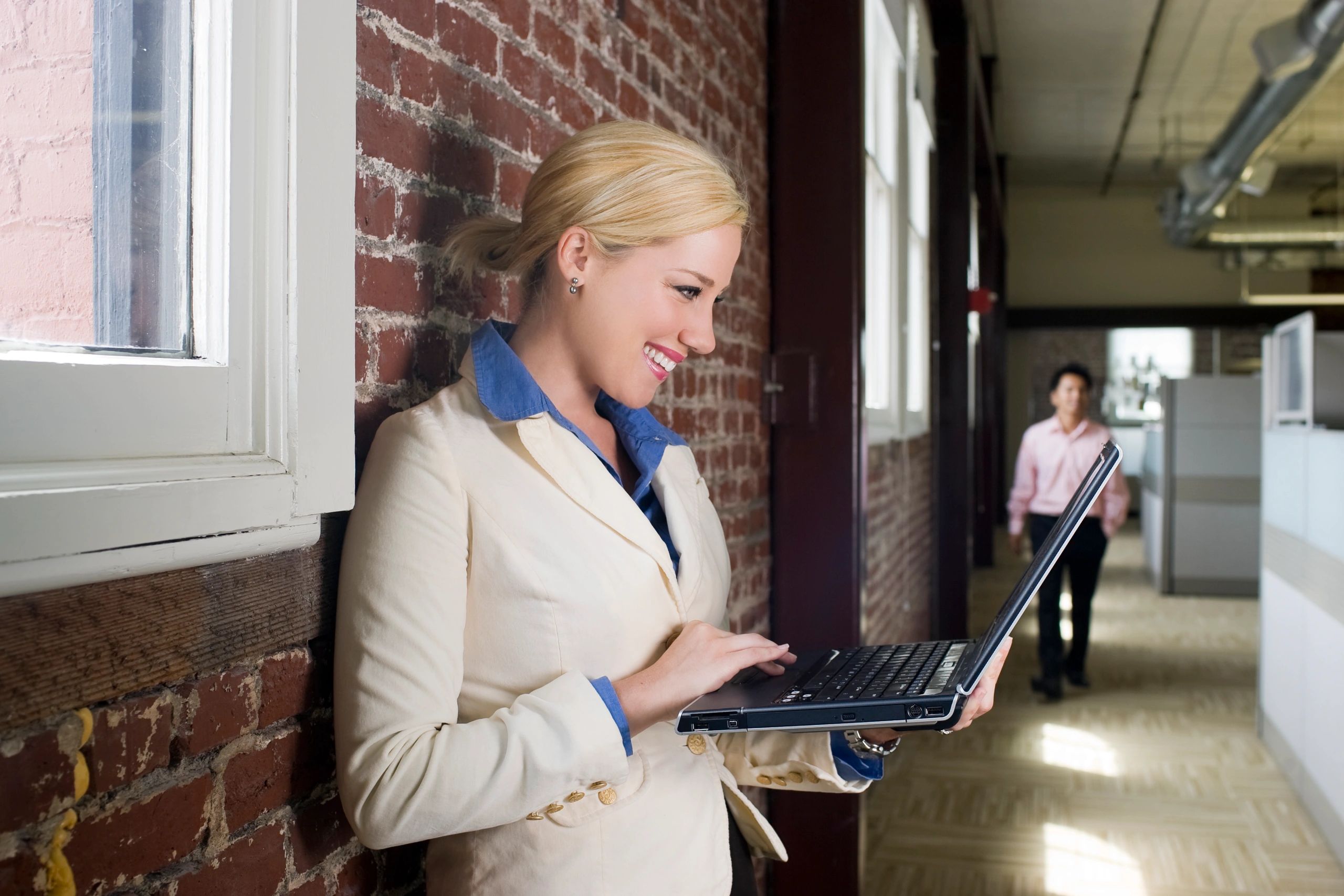 Woman using a laptop for a virtual session in a professional setting