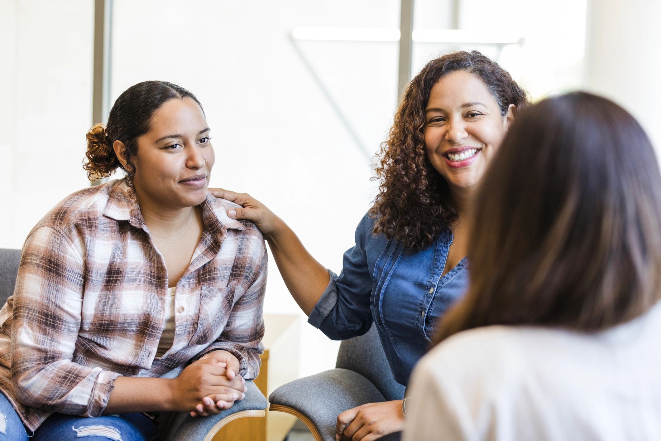 Mother and daughter meeting in a supportive counseling setting