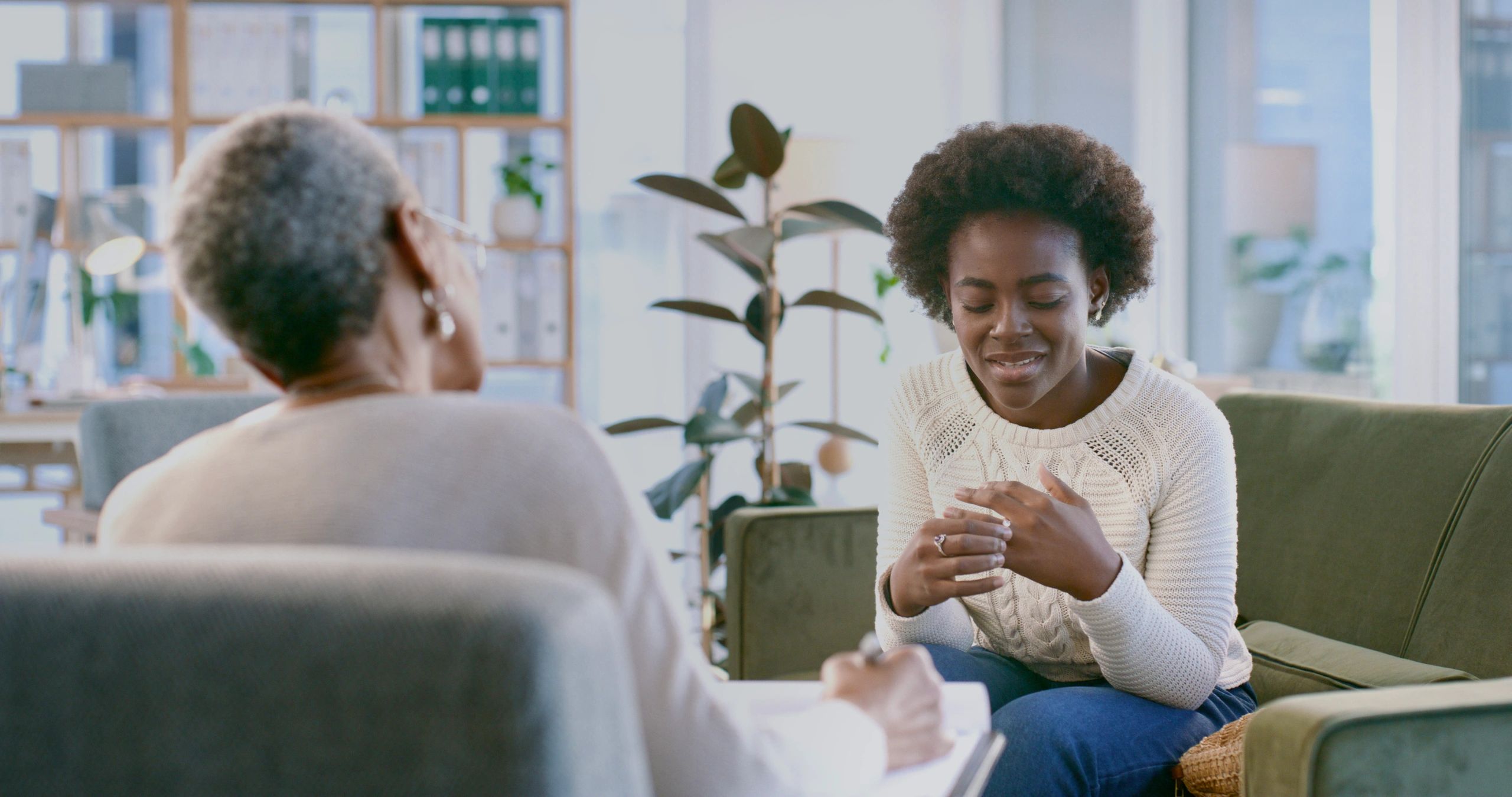 Young woman in a calm counseling session with a therapist in a cozy office